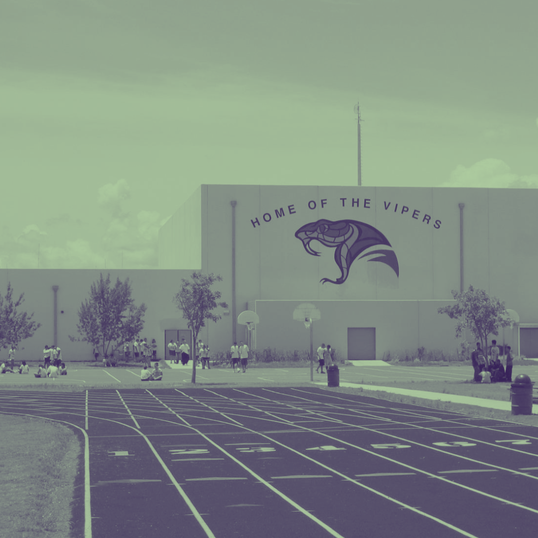 Felix Varela Senior High School track with building and school logo in the background